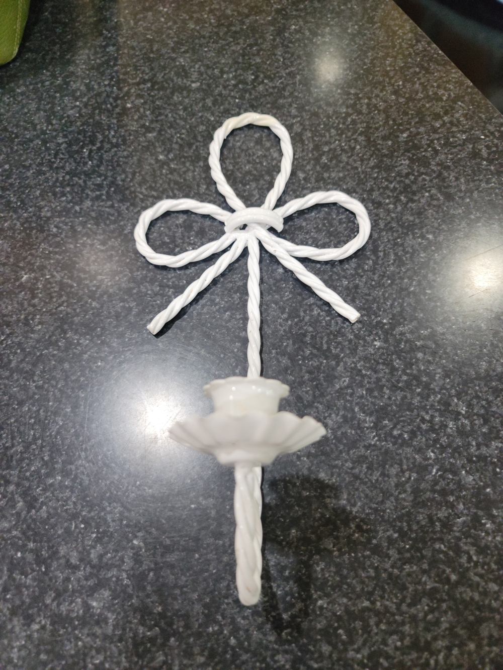 Vintage white metal wall sconce rope design topped with a bow